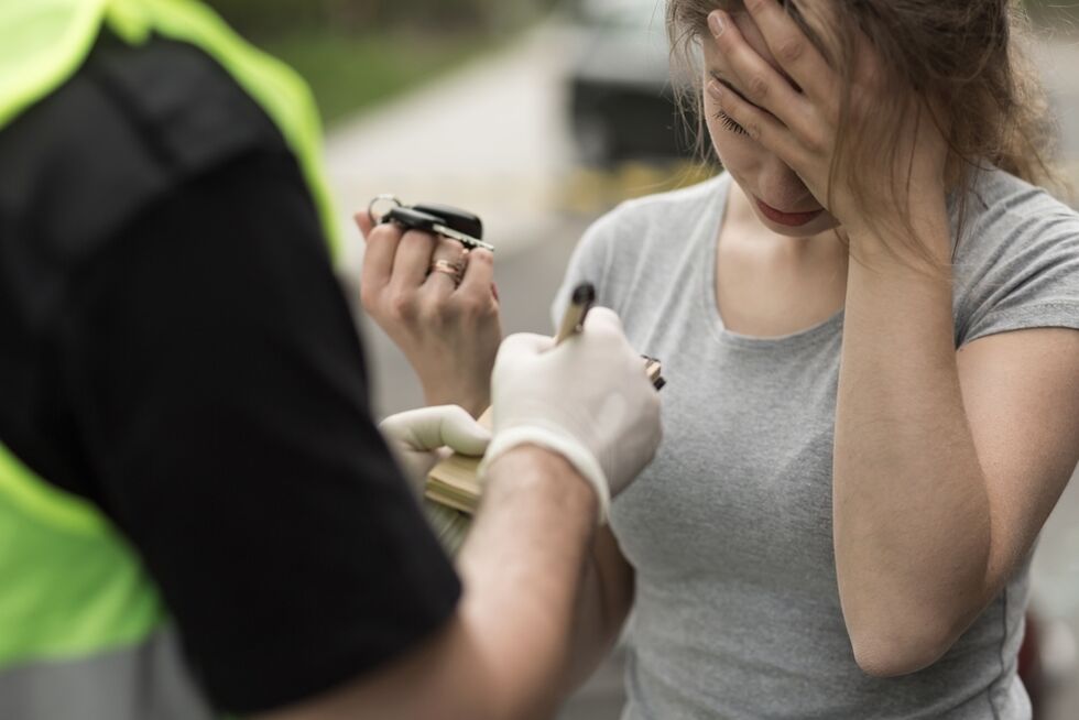 young driver being ticketed by police officer as an example of the Colorado DUI statute