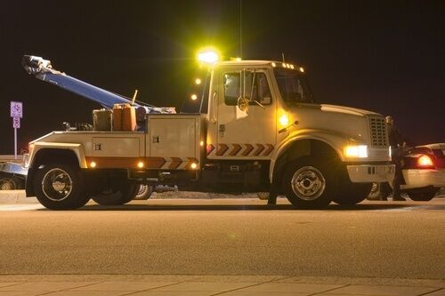 Tow truck about to tow an illegally parked vehicle; California impound laws are codified in 22651 CVC