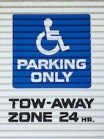 Handicapped parking space that warns violators will be towed