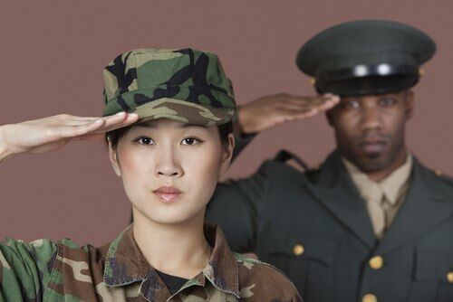 Young U.S. Marine Corps soldier and officer saluting, who are ineligible for CORs in California