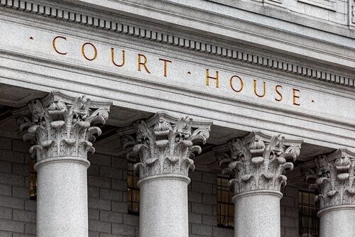 Front of California court building with ornate columns and the words “Court House” on the pediment