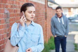 Woman on cell phone being talked by man on street