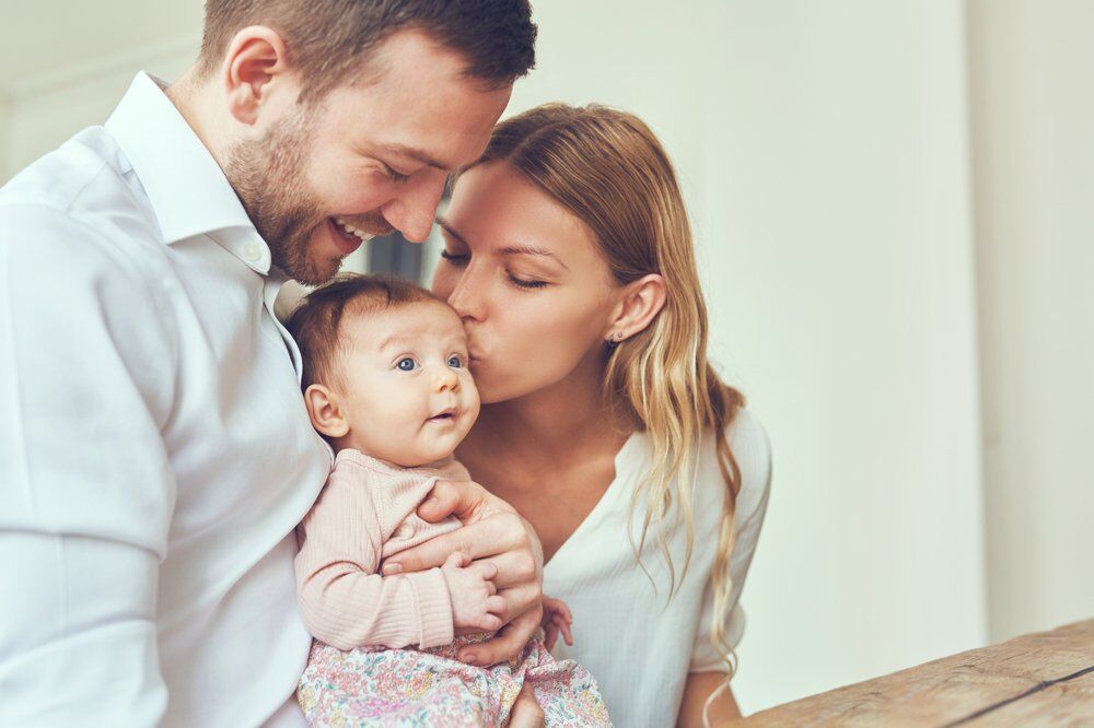 A young family with their newborn child.