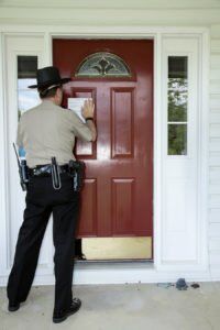 Sheriff outside of a home about to execute search warrant.