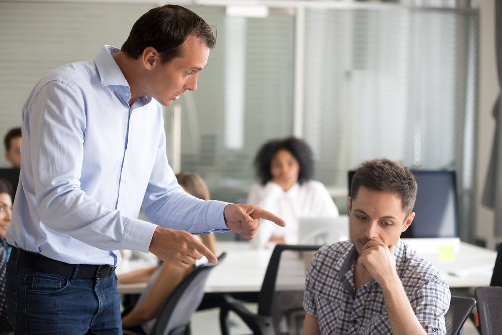 A boss scolding his employee.