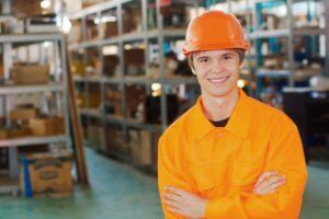 A smiling teen wearing hi-visibility workwear.